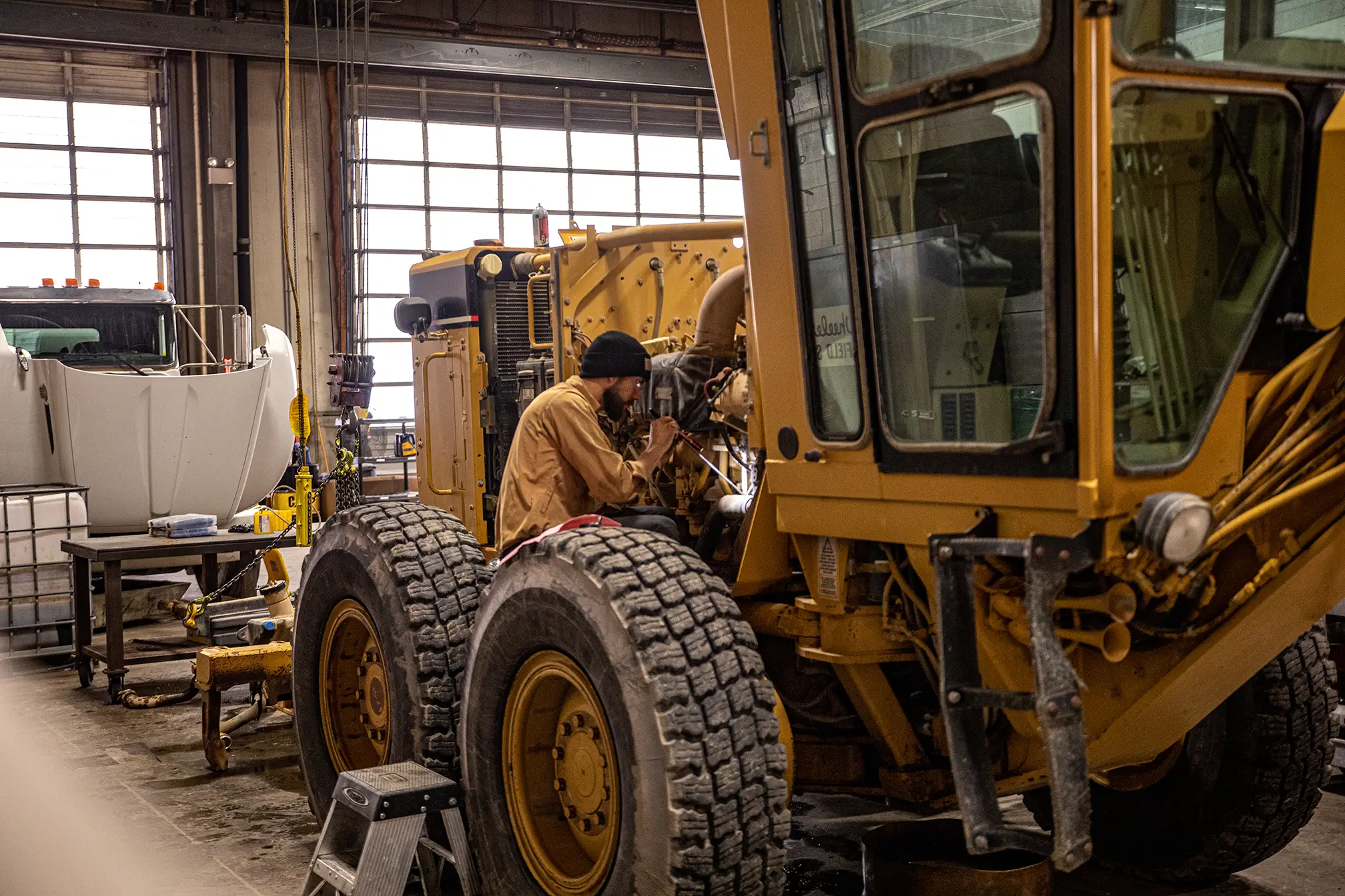 Wheeler Machinery technician working on motor grader engine