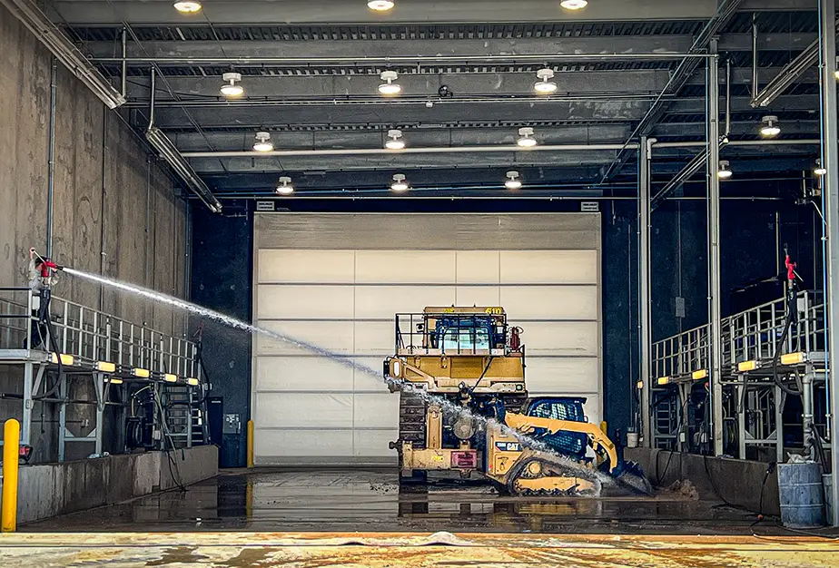 Dozer and compact track loader in Wheeler Machinery's wash bay.