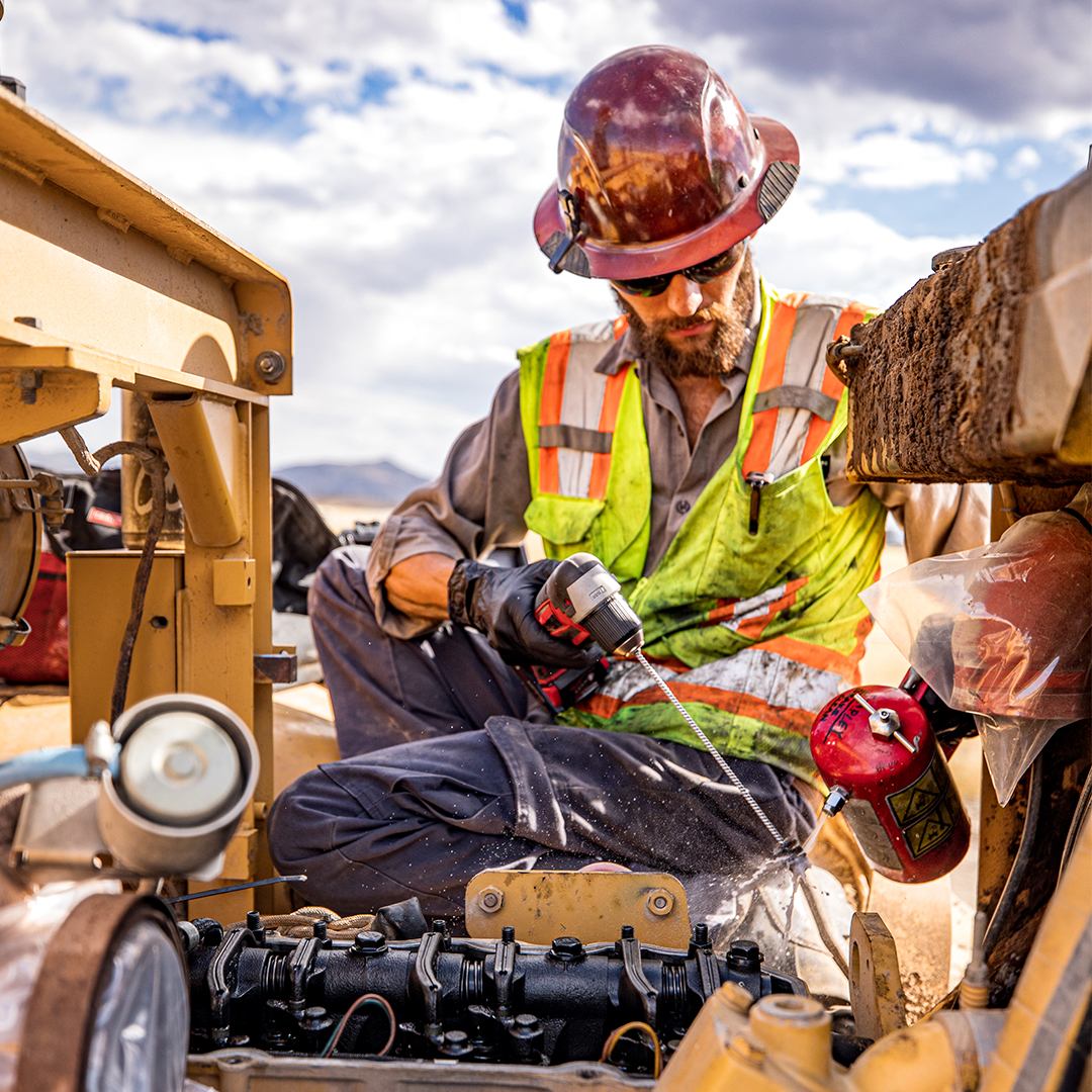 Machine technician working on heavy equipment