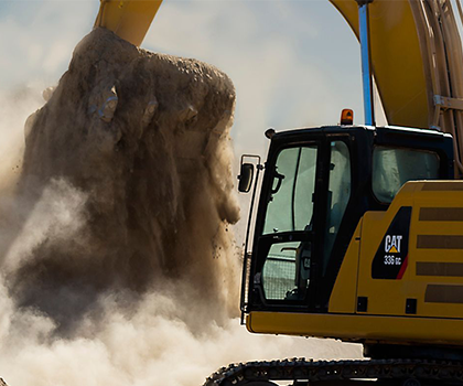 Cat ground engaging tools digging dirt on an excavator.